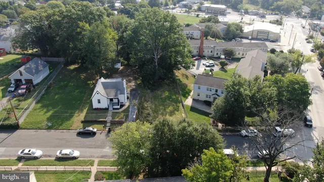 an aerial view of a house with a yard and large trees