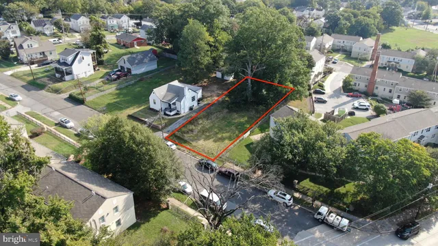 an aerial view of a house with a yard and large trees