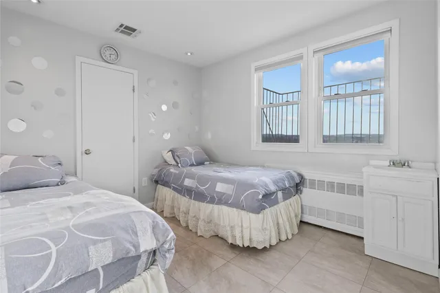 a bedroom with two beds and painted walls