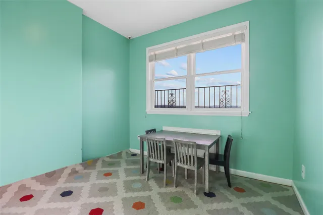 a dining room with furniture and a window