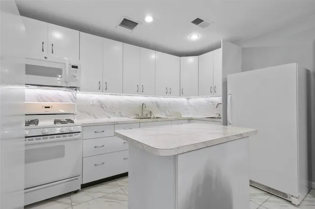 a kitchen with appliances cabinets and a sink