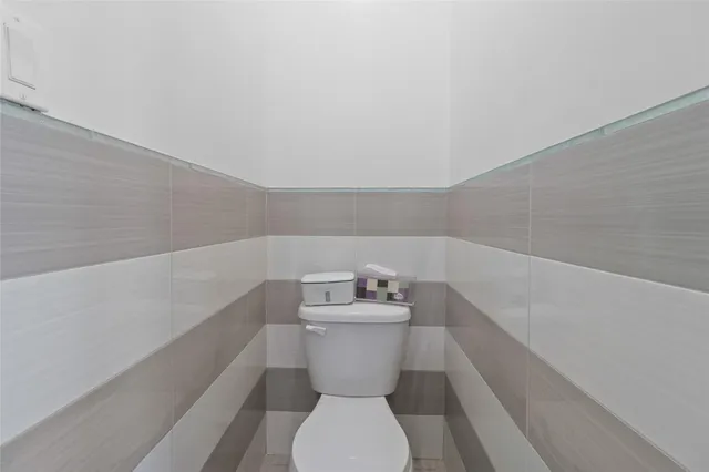 a bathroom with a sink mirror and toilet