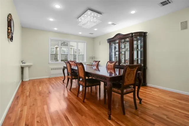 a view of a a dining room with furniture window and wooden floor