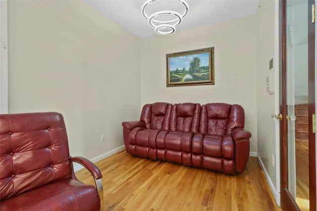 a living room with a couch and a potted plant