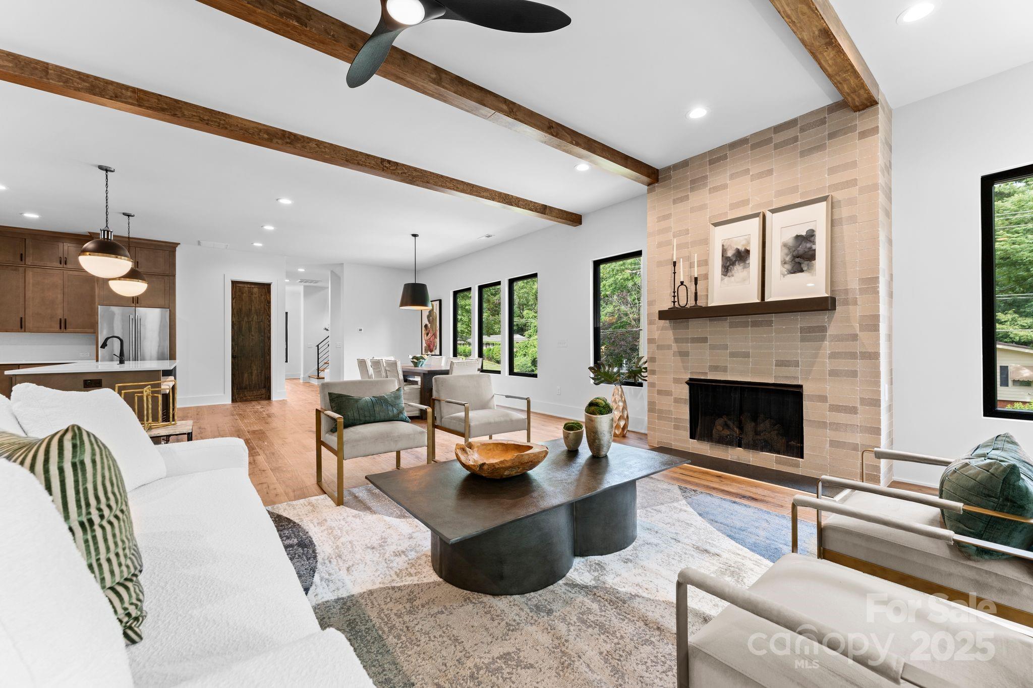 5610 Farmbrook Drive Charlotte, NC 28210 - Photo 11 of 45 a living room with furniture potted plant and a fireplace