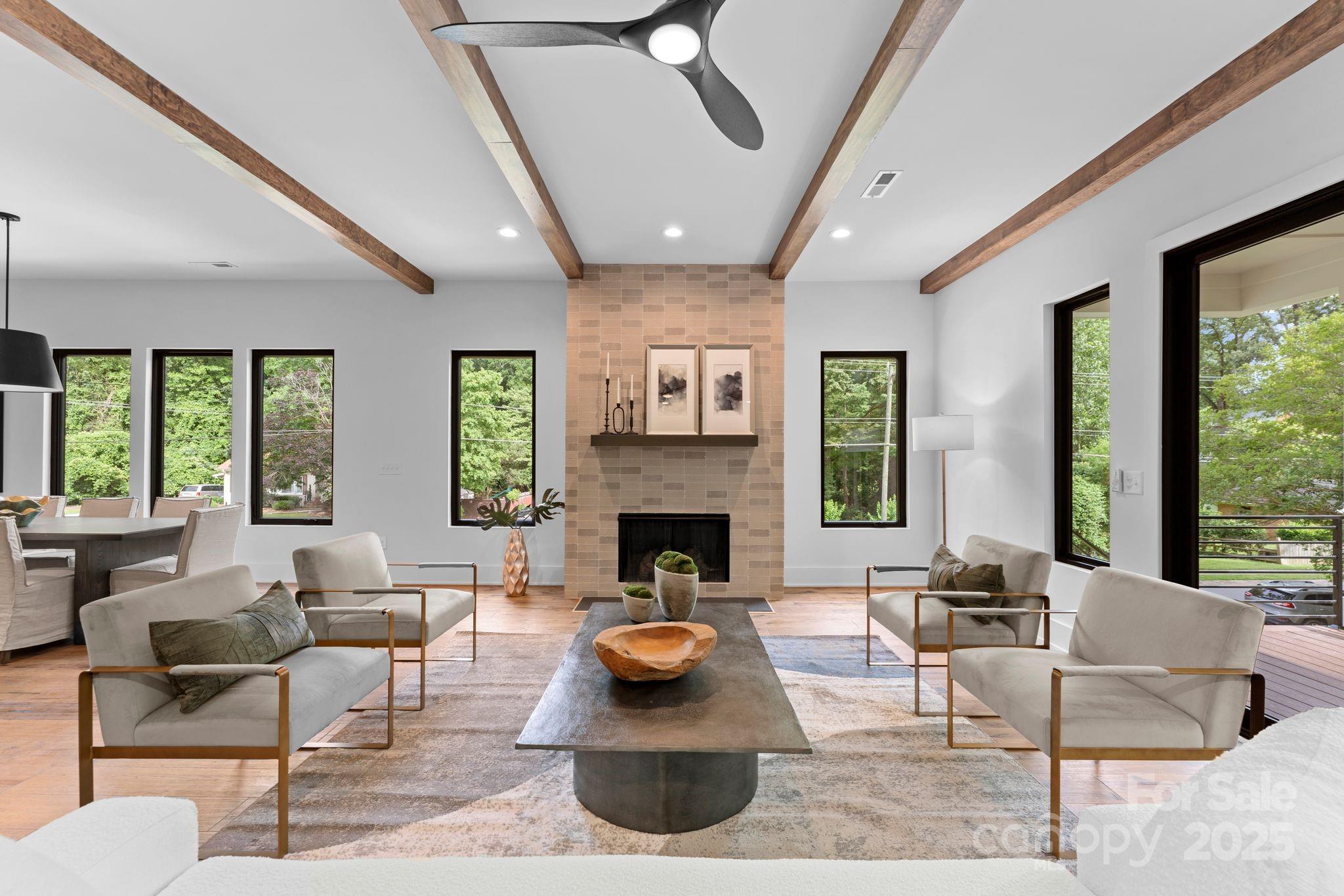 5610 Farmbrook Drive Charlotte, NC 28210 - Photo 12 of 45 a living room with furniture a fireplace and a large window