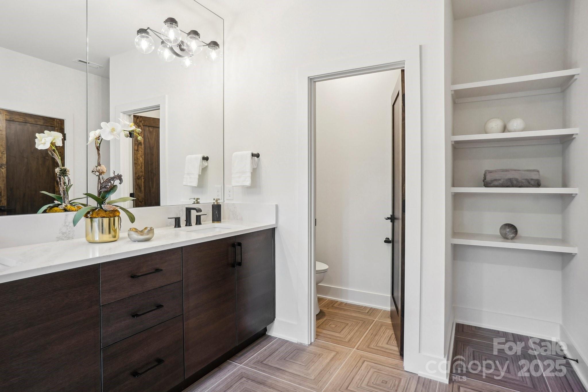5610 Farmbrook Drive Charlotte, NC 28210 - Photo 29 of 45 a bathroom with a double vanity sink a mirror and a shower