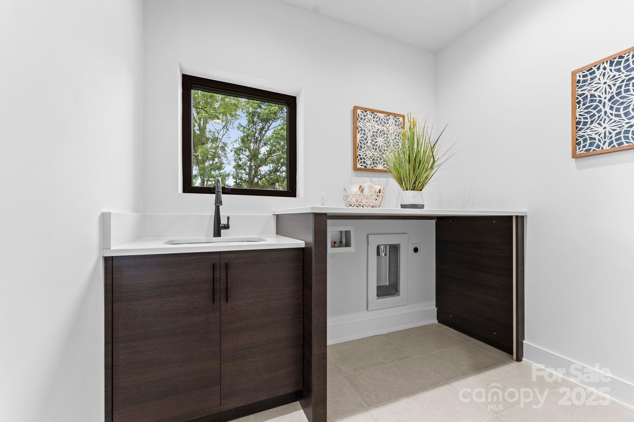 5610 Farmbrook Drive Charlotte, NC 28210 - Photo 31 of 45 a kitchen with a sink and a mirror