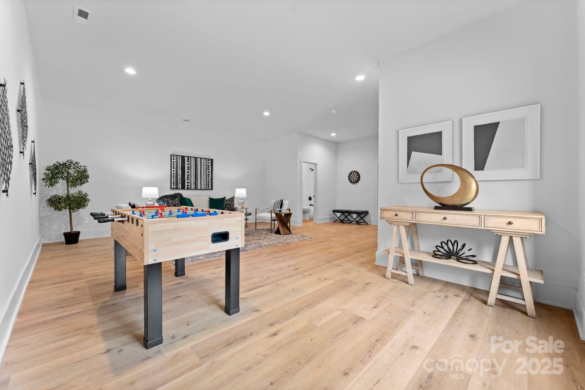 5610 Farmbrook Drive Charlotte, NC 28210 - Photo 37 of 45 a living room with furniture a rug and wooden floor