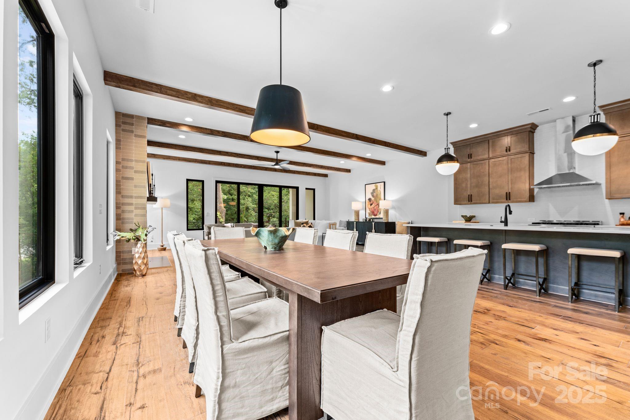 5610 Farmbrook Drive Charlotte, NC 28210 - Photo 7 of 45 a dining room with stainless steel appliances granite countertop a table and chairs with wooden floor