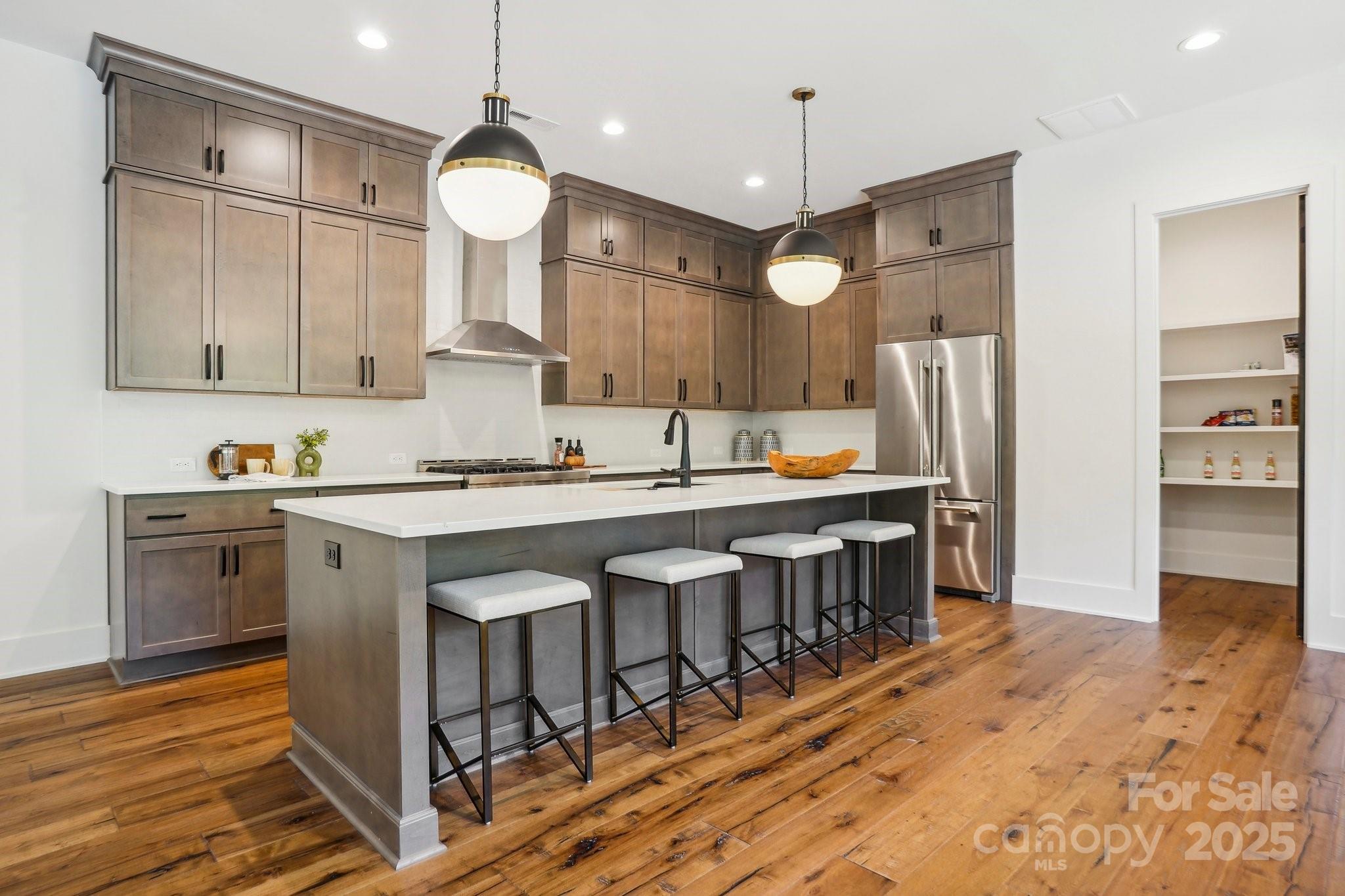 5610 Farmbrook Drive Charlotte, NC 28210 - Photo 8 of 45 a kitchen with granite countertop a stove a sink cabinets and wooden floor