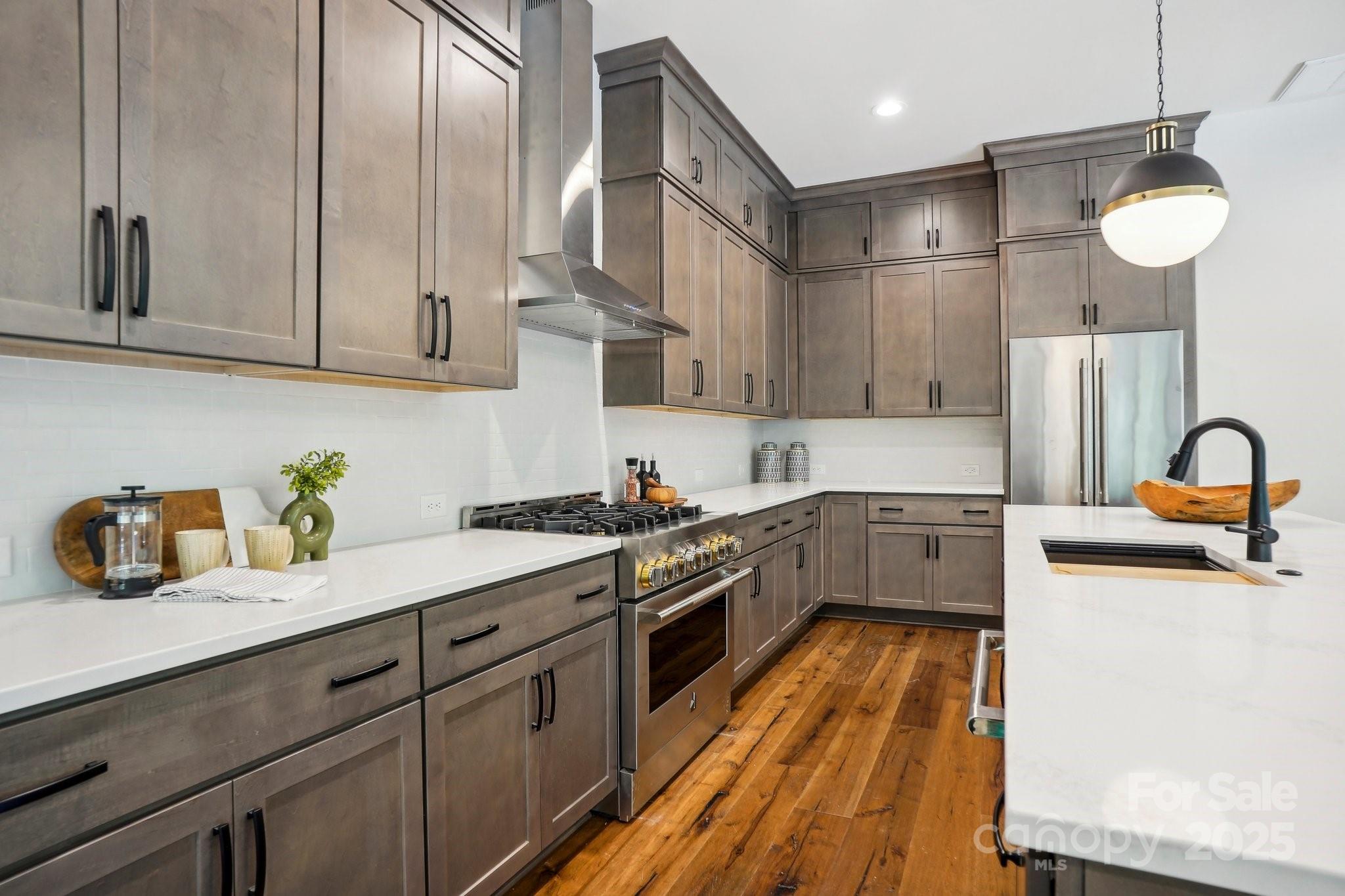 5610 Farmbrook Drive Charlotte, NC 28210 - Photo 9 of 45 a kitchen with granite countertop a stove a sink and a refrigerator