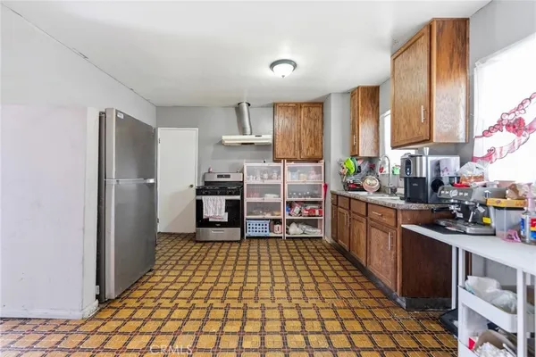 a kitchen with stainless steel appliances a refrigerator and a stove top oven