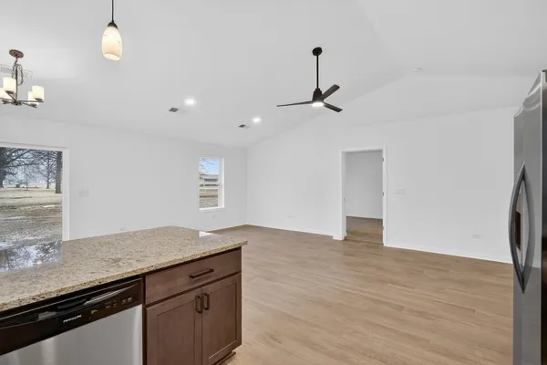 a view of a kitchen island wooden floor and staircase