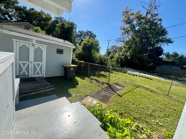 a view of a backyard with sitting area