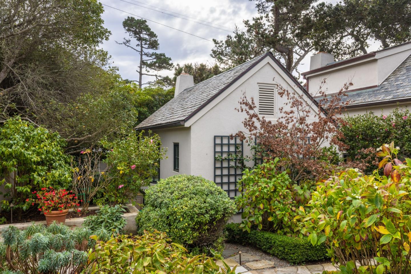 0 Northwest Nw Corner Carmel, CA 93923 - Photo 11 of 13 a white house with a small yard plants and large trees