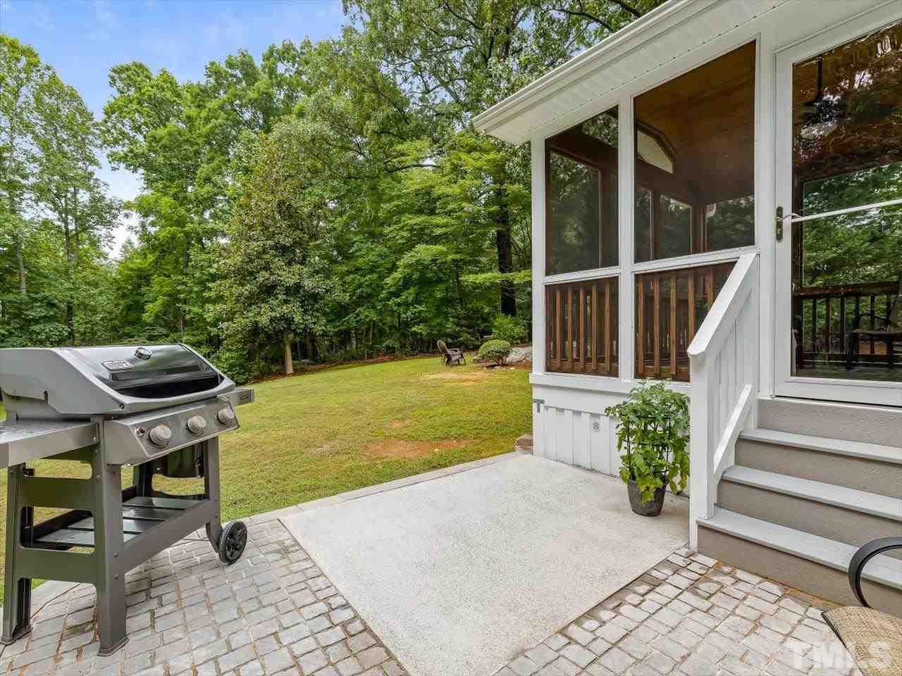6441 Guess Road Durham, NC 27712 - Photo 16 of 30 a view of a patio with table and chairs potted plants with wooden floor and fence