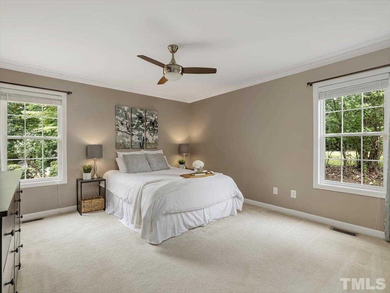 6441 Guess Road Durham, NC 27712 - Photo 17 of 30 a spacious bedroom with a bed and a large window