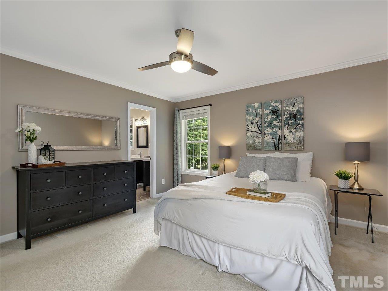 6441 Guess Road Durham, NC 27712 - Photo 18 of 30 a bed room with a bed and a mirror on dresser