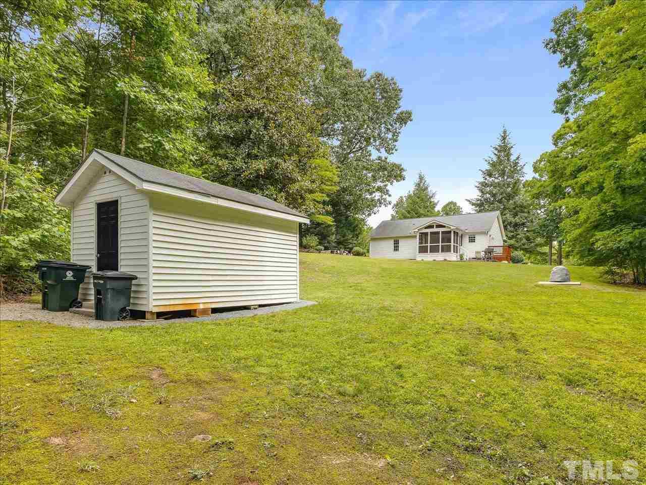 6441 Guess Road Durham, NC 27712 - Photo 26 of 30 a front view of house with yard and trees in the background