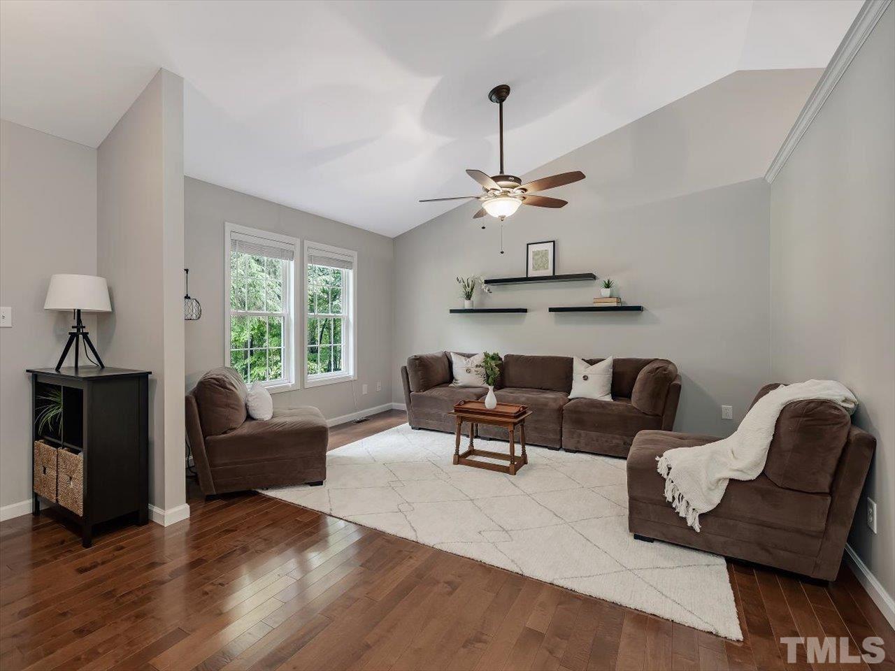 6441 Guess Road Durham, NC 27712 - Photo 8 of 30 a living room with furniture and a chandelier