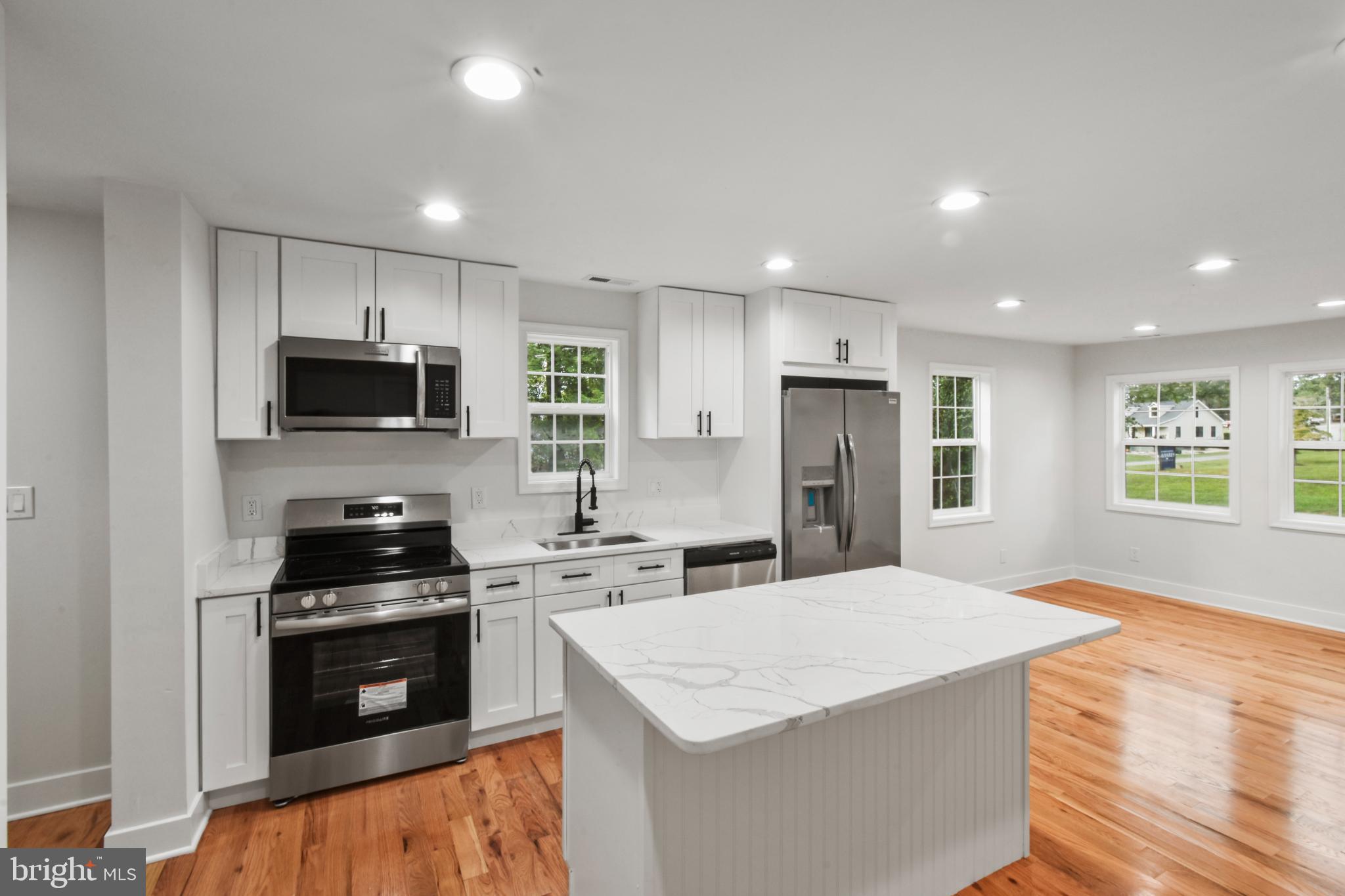 18084 Monrovia Road Orange, VA 22960 - Photo 15 of 28 a kitchen with stainless steel appliances kitchen island a stove a sink a microwave and cabinets