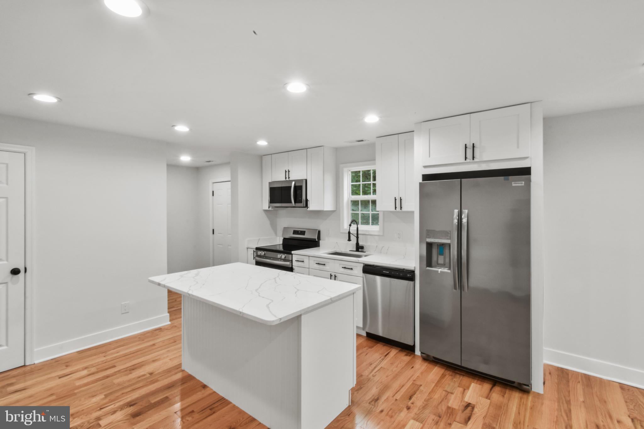 18084 Monrovia Road Orange, VA 22960 - Photo 16 of 28 a kitchen with refrigerator cabinets and wooden floor