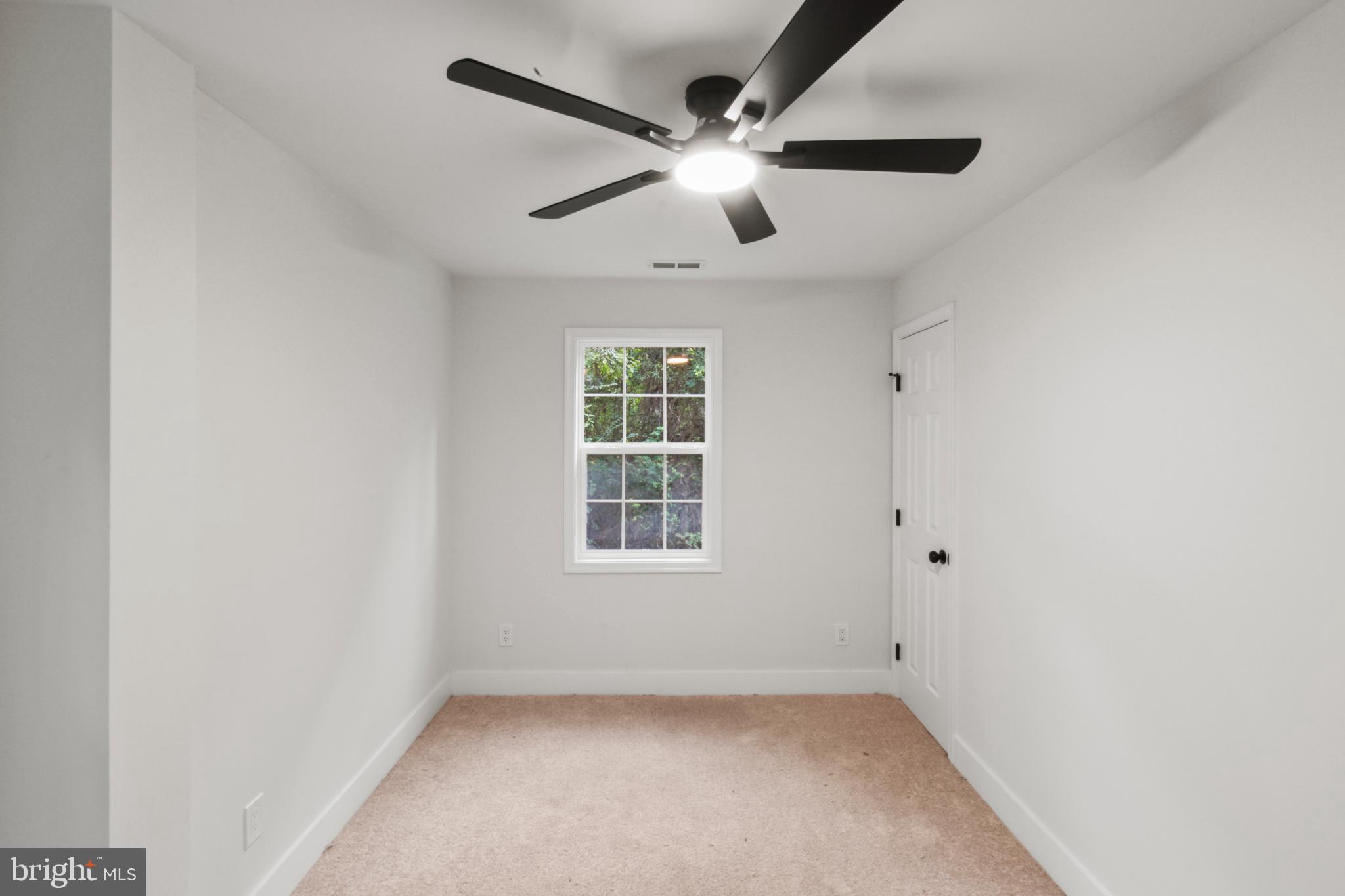 18084 Monrovia Road Orange, VA 22960 - Photo 20 of 28 an empty room with window and ceiling fan