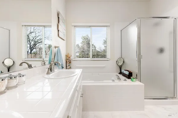 a bathroom with a tub sink and mirror