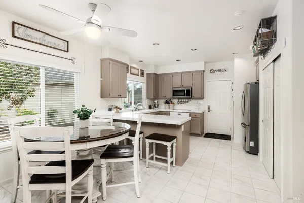a kitchen with a sink appliances and cabinets