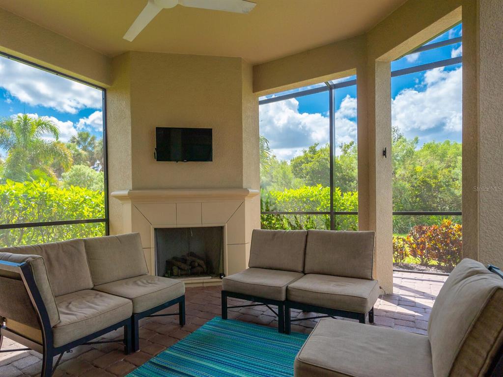 3929 Waypoint Avenue Osprey, FL 34229 - Photo 17 of 56 a living room with furniture and a fireplace