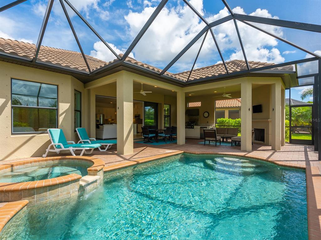 3929 Waypoint Avenue Osprey, FL 34229 - Photo 18 of 56 a view of a patio with table and chairs under an umbrella