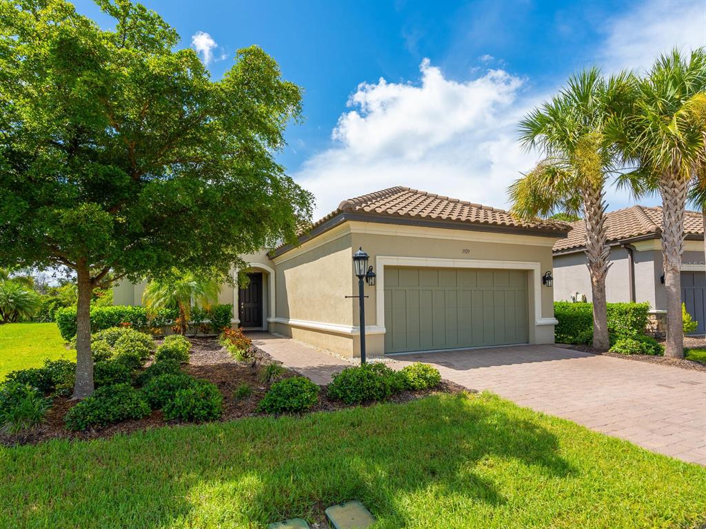 3929 Waypoint Avenue Osprey, FL 34229 - Photo 2 of 56 a front view of house with yard and green space