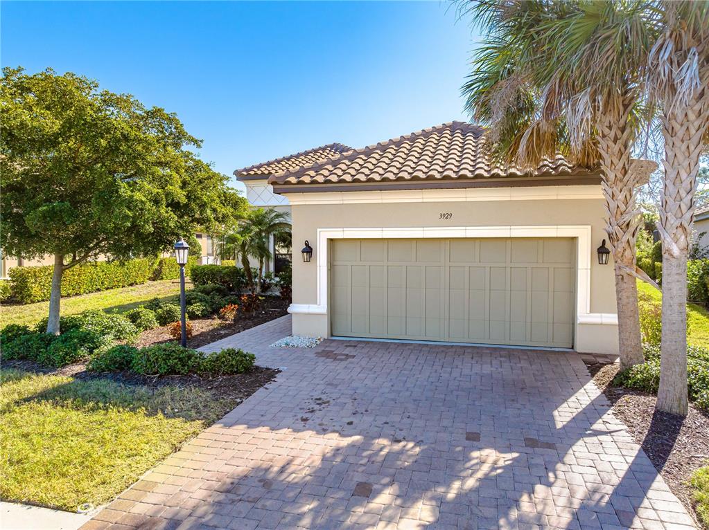 3929 Waypoint Avenue Osprey, FL 34229 - Photo 21 of 56 a front view of a house with garden