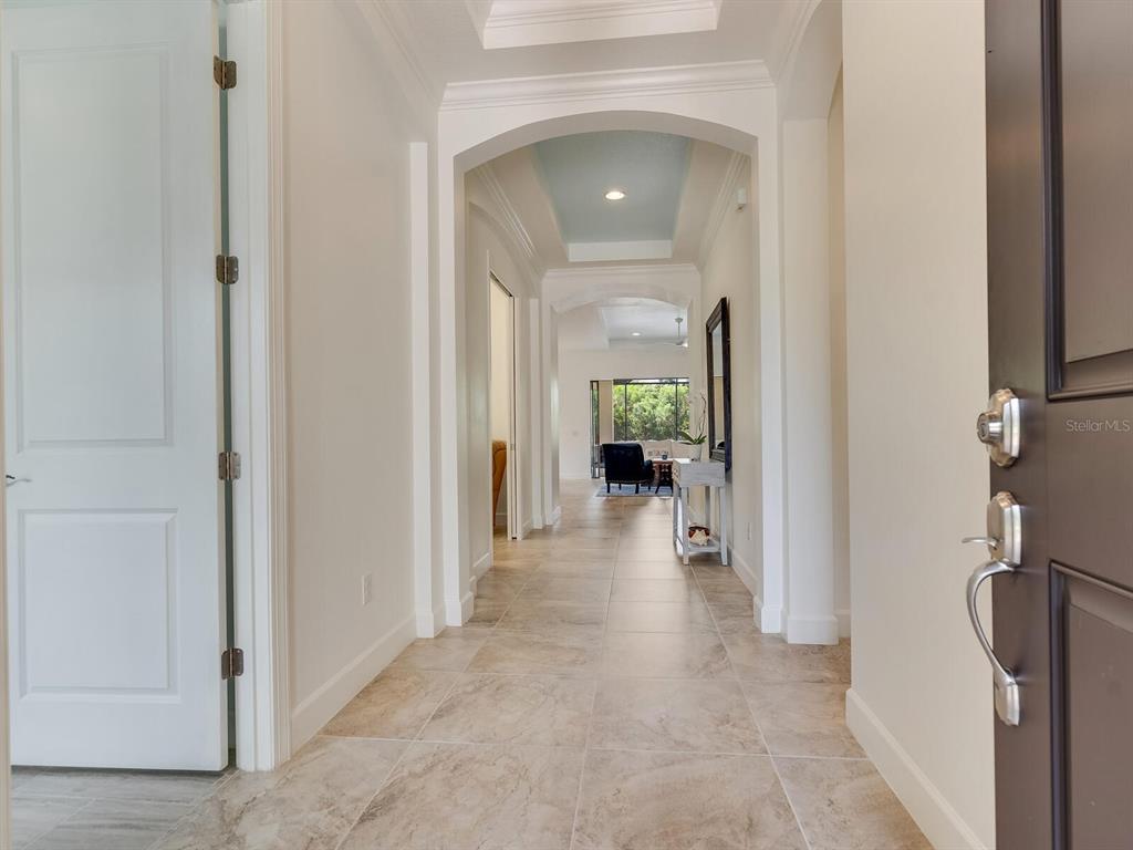 3929 Waypoint Avenue Osprey, FL 34229 - Photo 3 of 56 a view of a hallway with wooden shelves