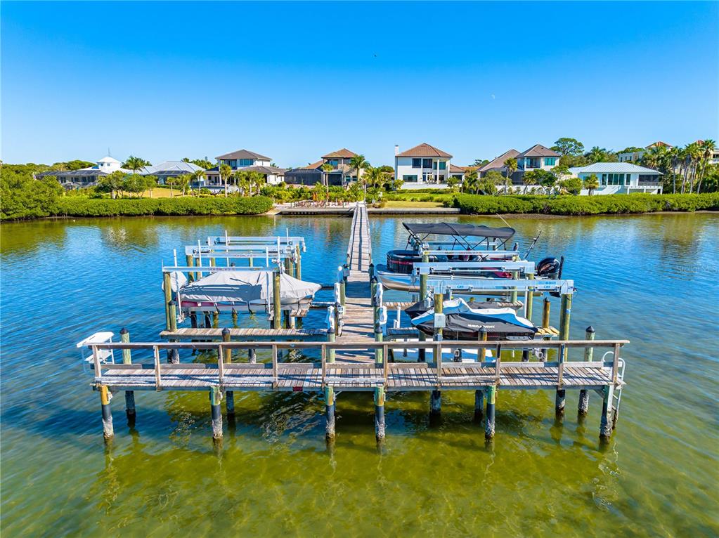 3929 Waypoint Avenue Osprey, FL 34229 - Photo 50 of 56 a view of a lake with a table and chairs