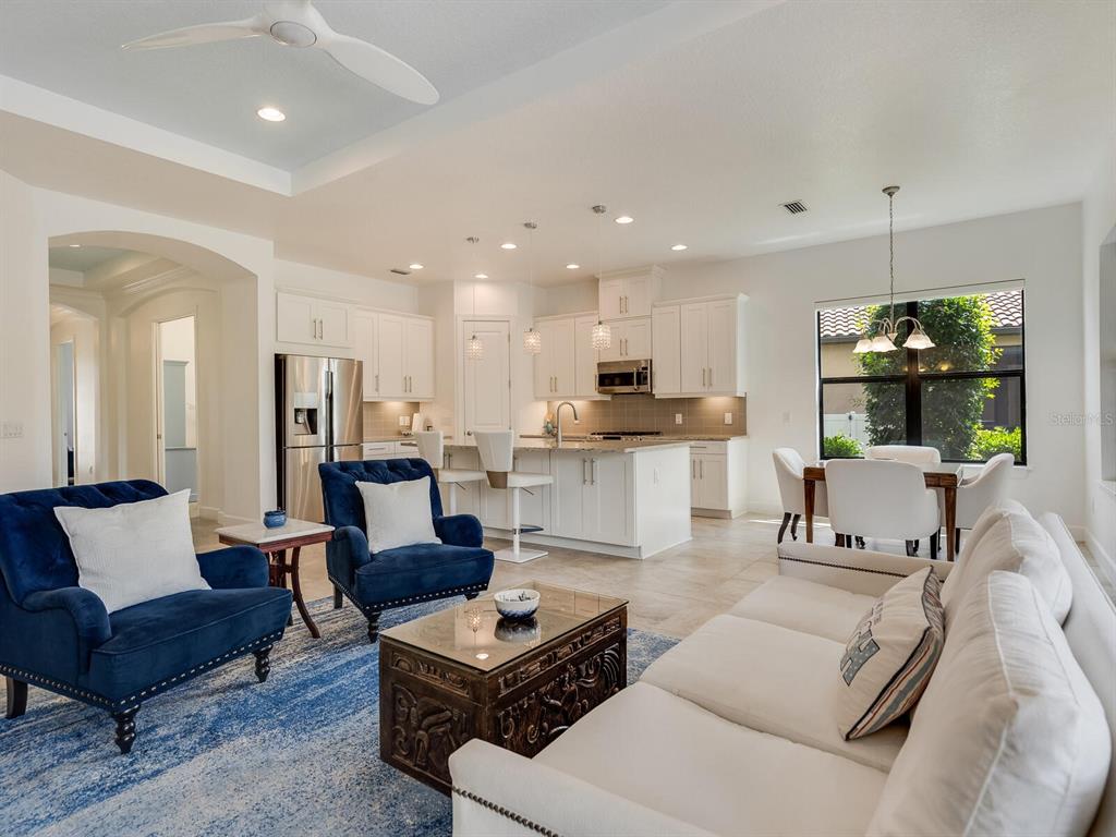 3929 Waypoint Avenue Osprey, FL 34229 - Photo 5 of 56 a living room with furniture kitchen and a dining table with kitchen view