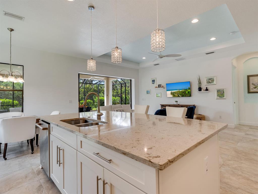 3929 Waypoint Avenue Osprey, FL 34229 - Photo 8 of 56 a kitchen with stainless steel appliances granite countertop a sink a stove and a refrigerator