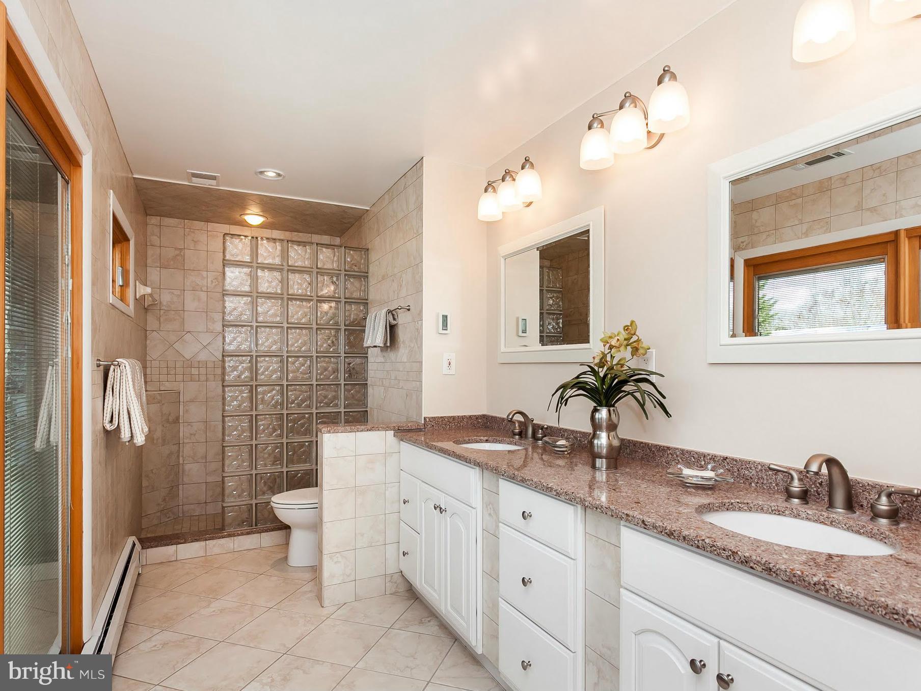 5200 Patterson Farm Road Baldwin, MD 21013 - Photo 20 of 30 a bathroom with a granite countertop double vanity sink mirror and shower