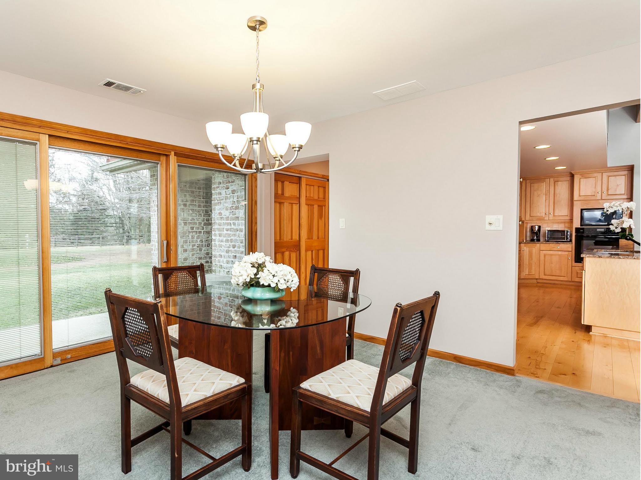 5200 Patterson Farm Road Baldwin, MD 21013 - Photo 7 of 30 a dining room with furniture a chandelier and large windows