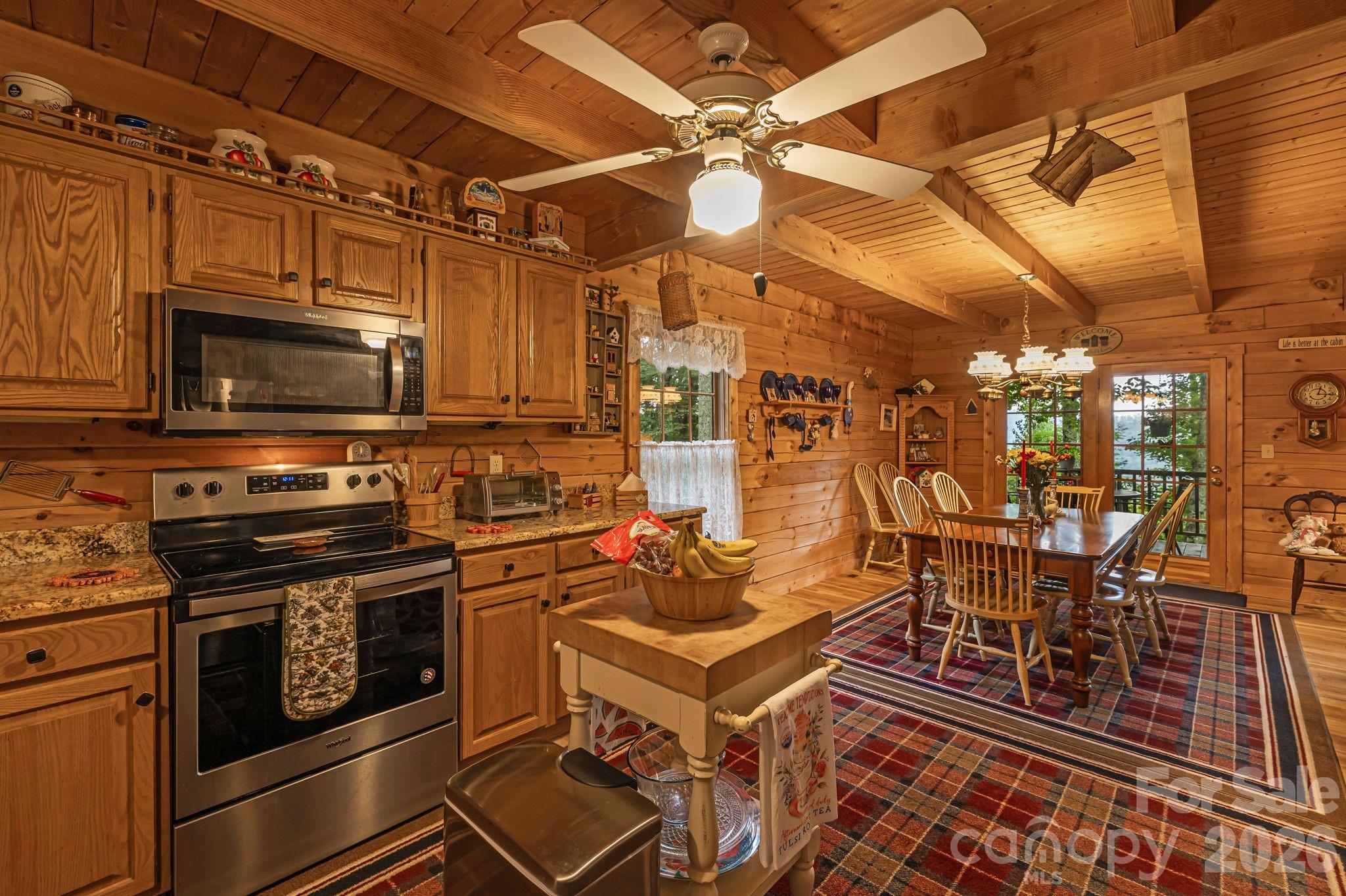 215 Goldenleaf Road Mars Hill, NC 28754 - Photo 12 of 47 a kitchen with a stove a microwave and furniture