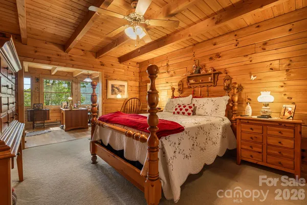 a bed sitting in a bedroom next to a window