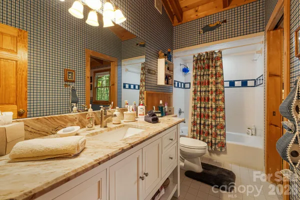 a bedroom with a bed and a television