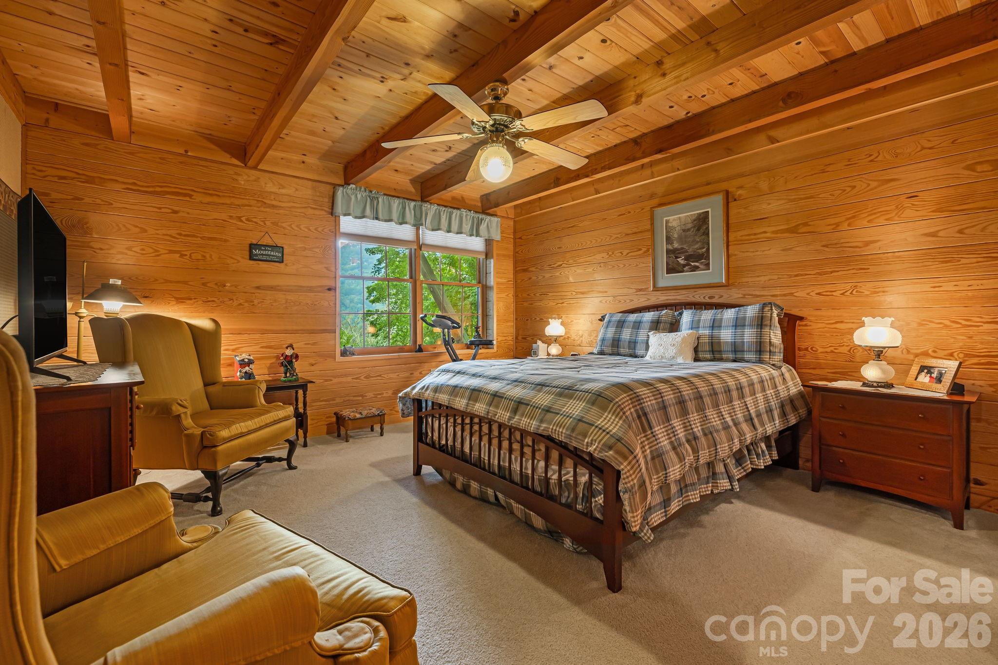 215 Goldenleaf Road Mars Hill, NC 28754 - Photo 31 of 47 a spacious bedroom with a bed and wooden floor