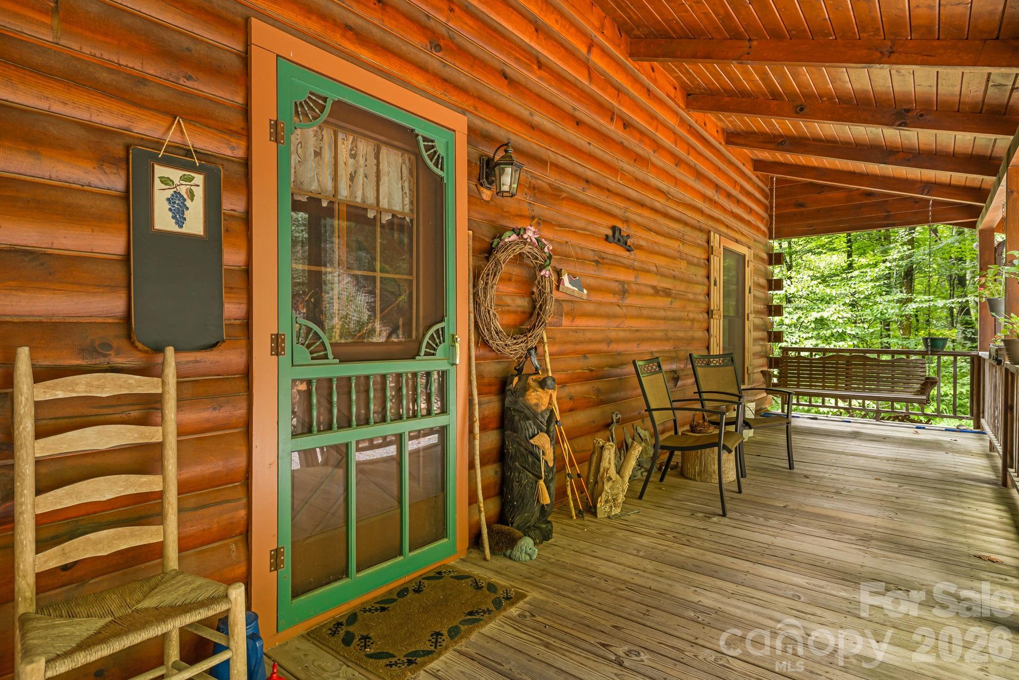 215 Goldenleaf Road Mars Hill, NC 28754 - Photo 5 of 47 a view of a patio with table and chairs and wooden floor