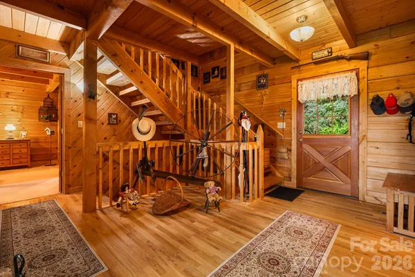 a kitchen with a stove a microwave and furniture