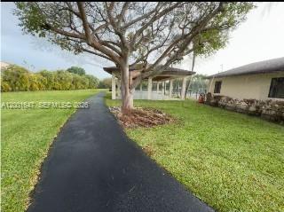 7010 Southwest 103rd Place Miami, FL 33173 - Photo 8 of 10 a front view of a house with garden