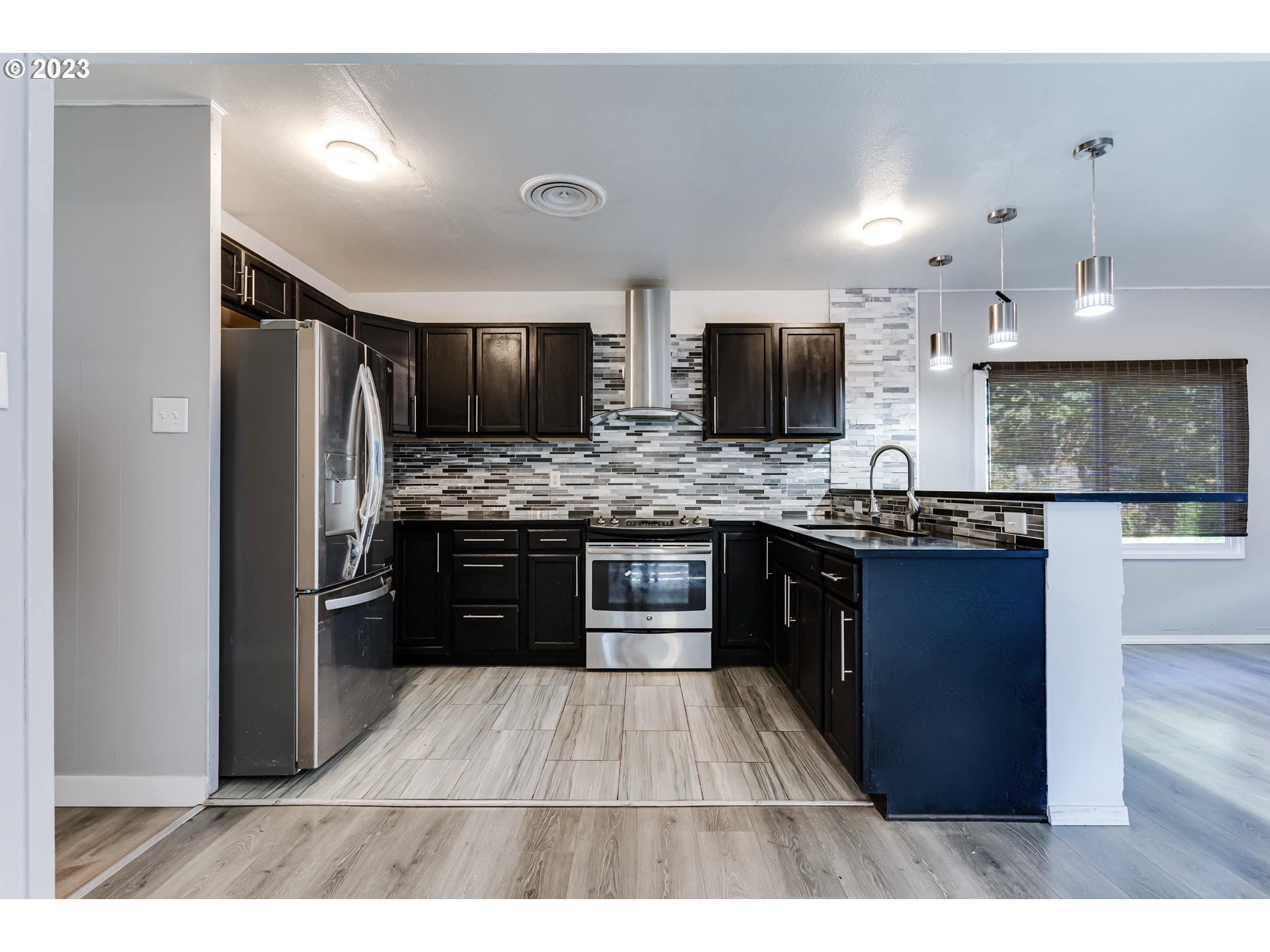 2013 Inland Way Springfield, OR 97477 - Photo 5 of 25 a large kitchen with a large counter top stainless steel appliances and cabinets