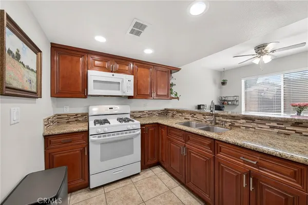 a kitchen with a stove sink and cabinets