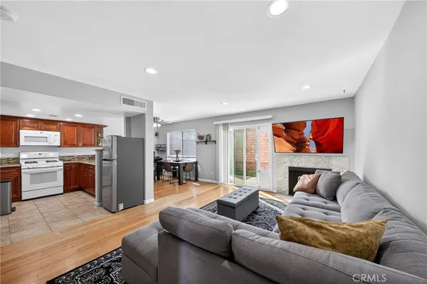 a living room with furniture fireplace and flat screen tv